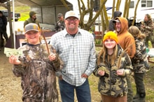 Two hunters in blaze orange vests and camo standing together holding multiple harvested pheasants at the 2024 R3 Upland Bird Hunt