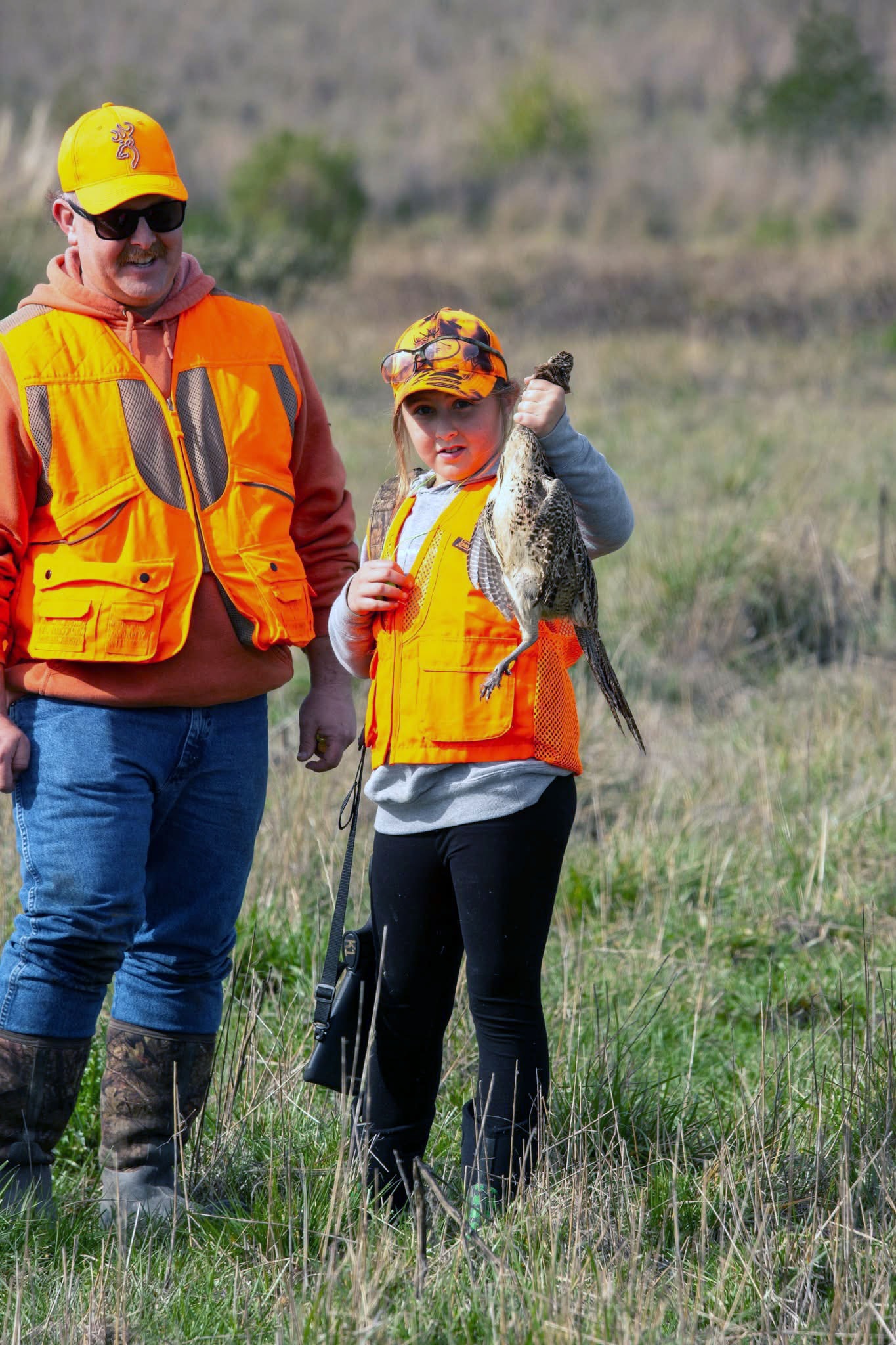 Adult and youth fishing together outdoors