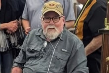 Jim Barrango seated beside the event display