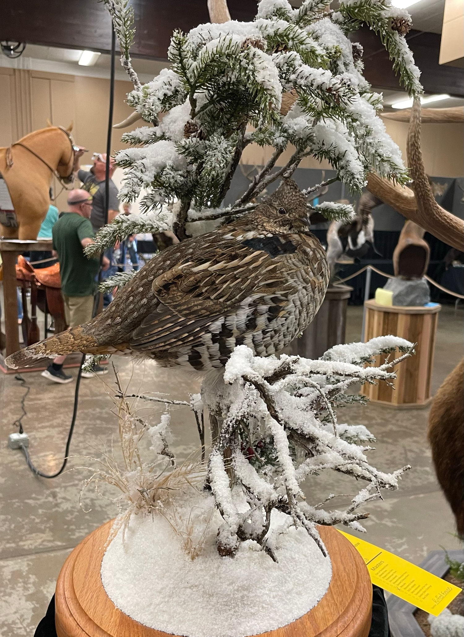 Snow-covered upland game bird taxidermy display at the event